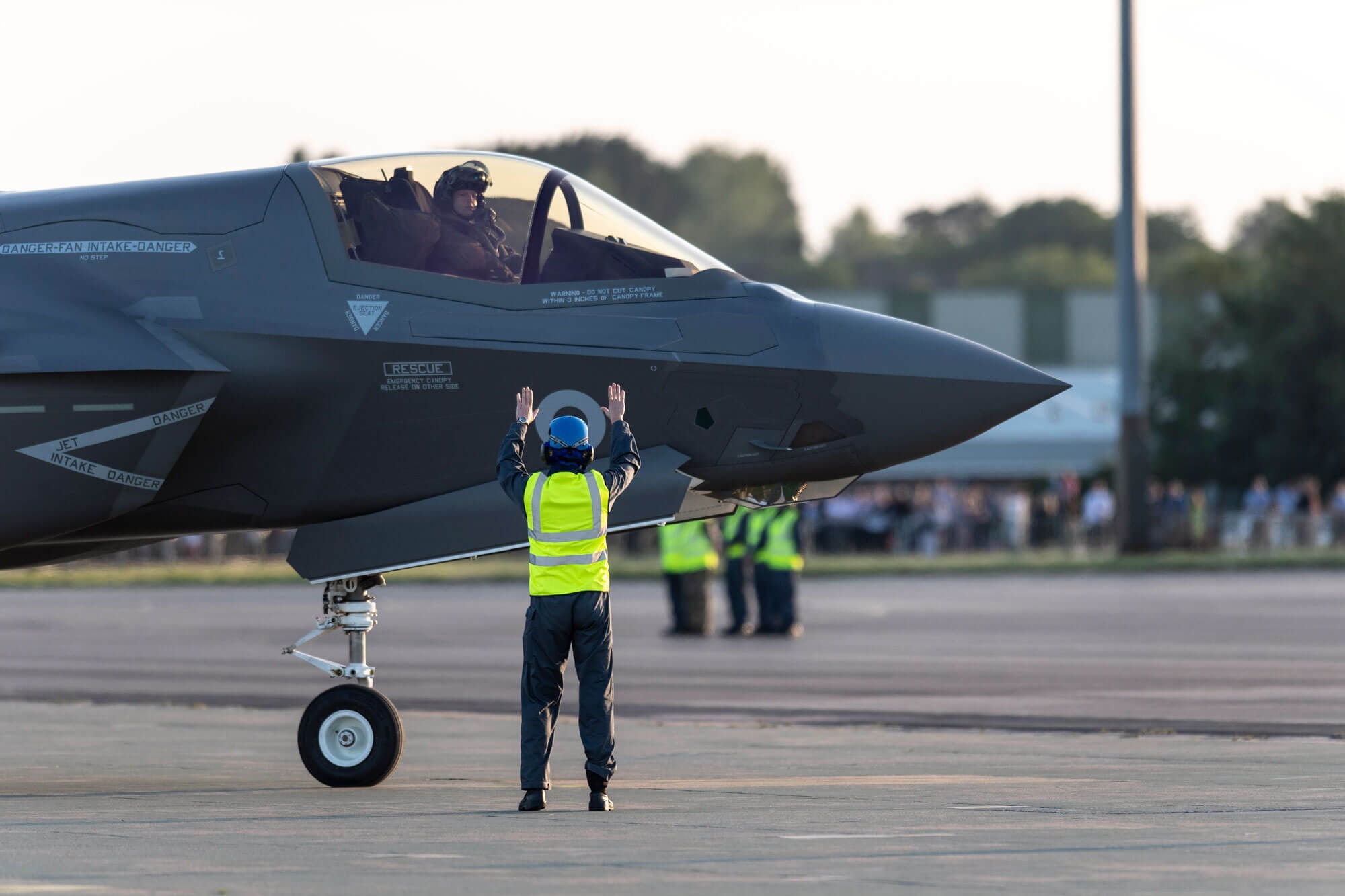 large grey fighter jet landson runway