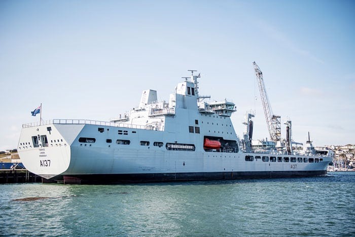 A large grey navy tanker ship at sea