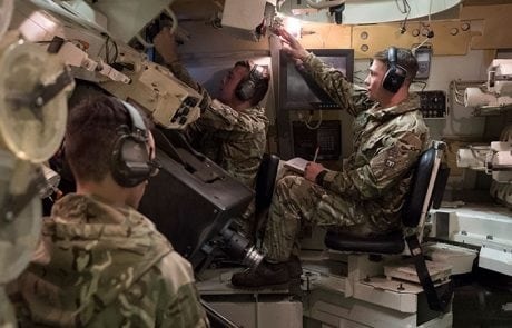 solider in a tank simulator wearing headset