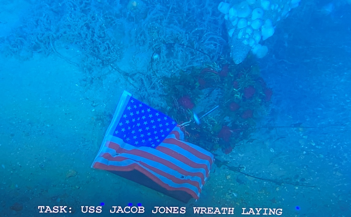 A wreath and Stars and Stripes flag laid on the wreck of USS Jacob Jones