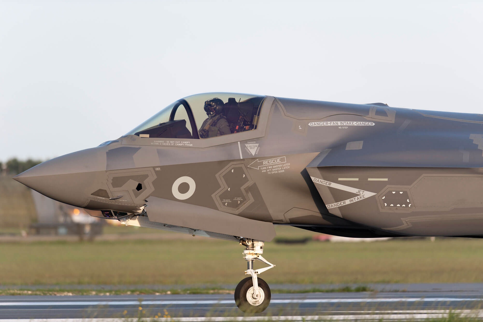 large grey fighter jet landson runway