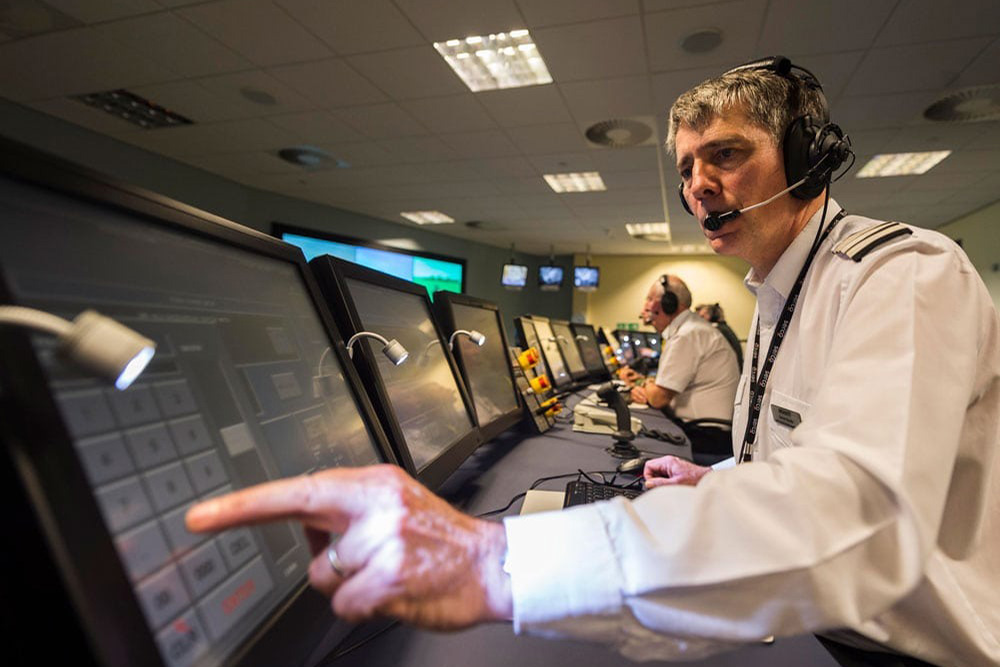 A military man views data on a screen