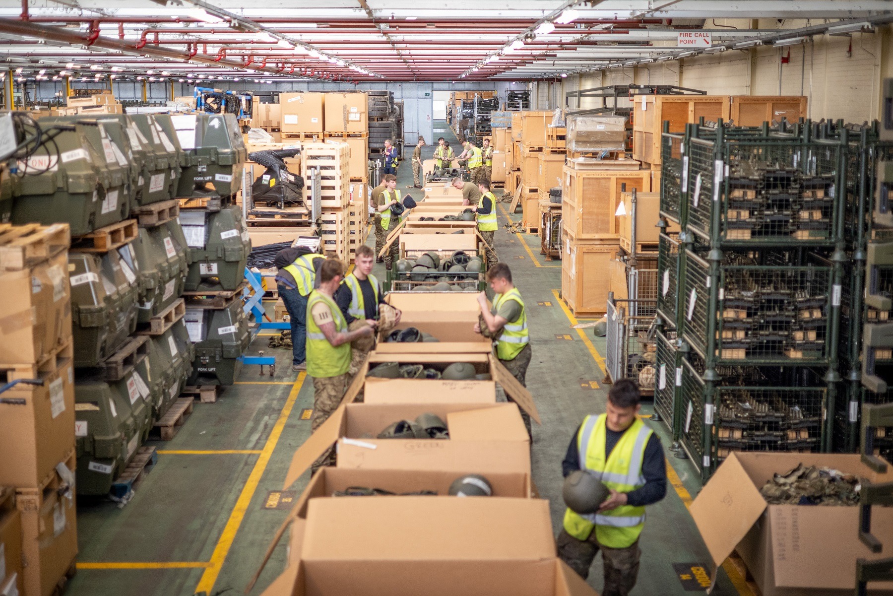 Soldiers from 2nd Battalion The Royal Anglian Regiment checks helmets and prepares them for packaging at MOD Donnington.
