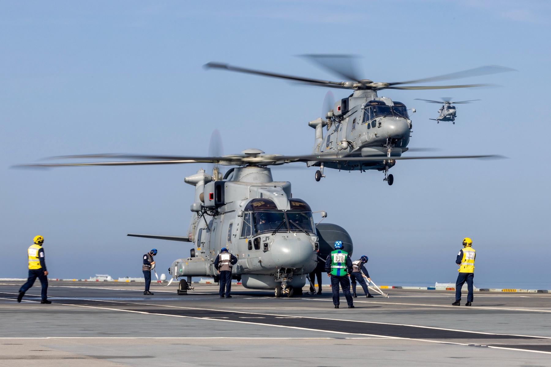 A Merlin helicopter on the deck of HMS Queen Elizabeth during the Carrier Strike Group deployment 2023