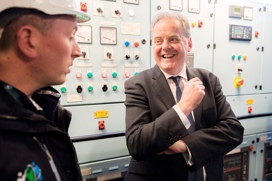 man in a suit interviews a navy officer
