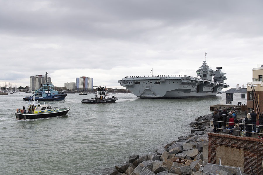 Large Royal Navy ship sailing into Portsmouth harbour
