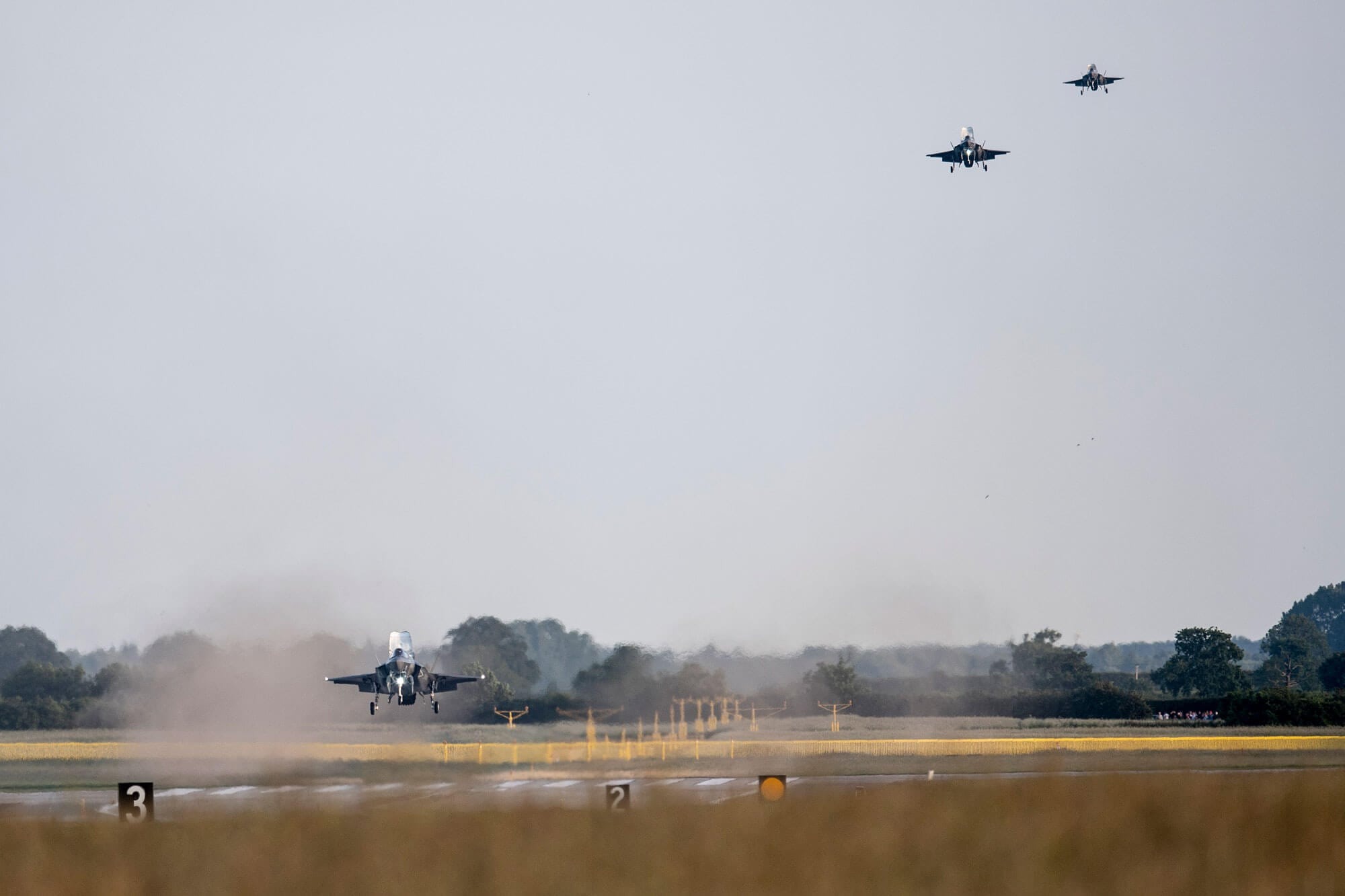 fighter jets landing in a row
