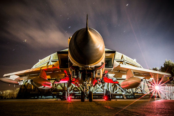fighter jet aircraft stationary with red under lighting