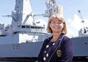 MP Harriett Baldwin stood smiling with Type 45 navy warship