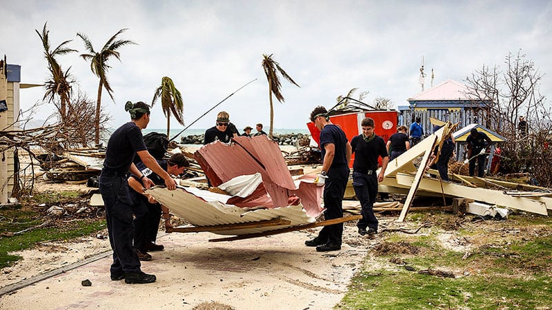 royal navy teams clear up damaged house after hurricane