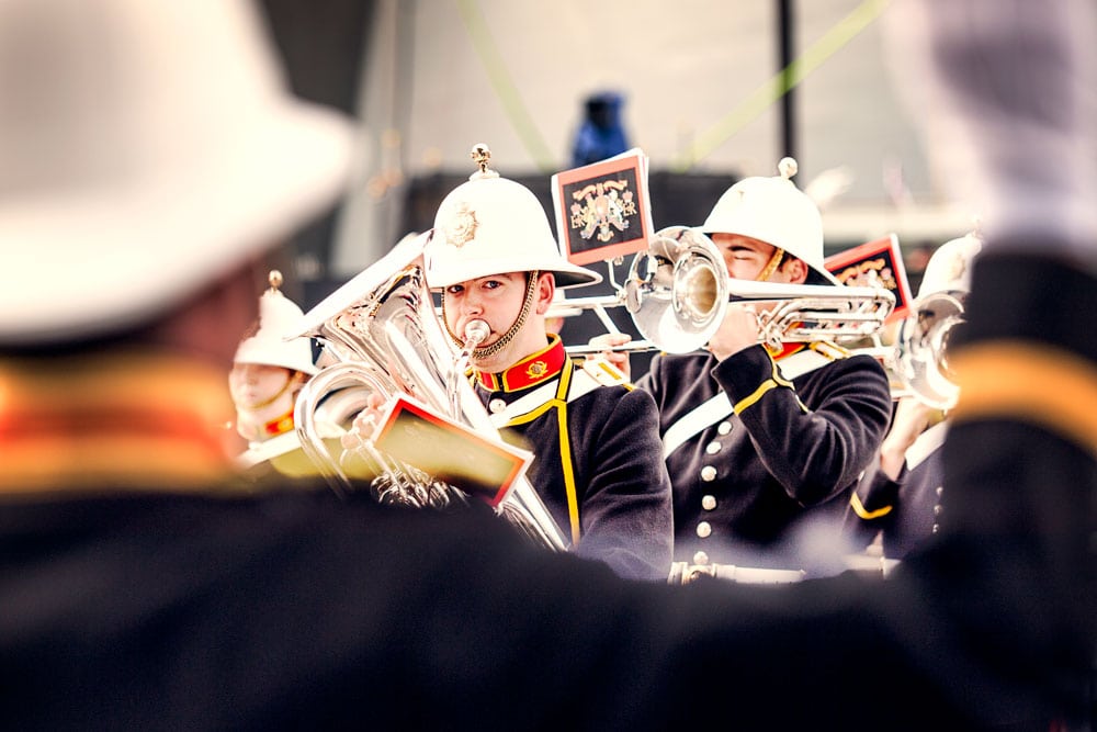 A navy marching band playing their instruments