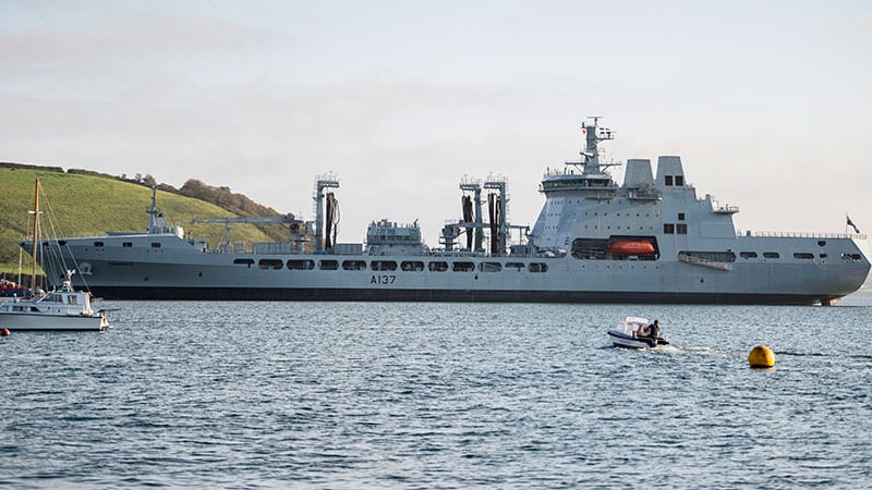 A large grey navy tanker ship at sea