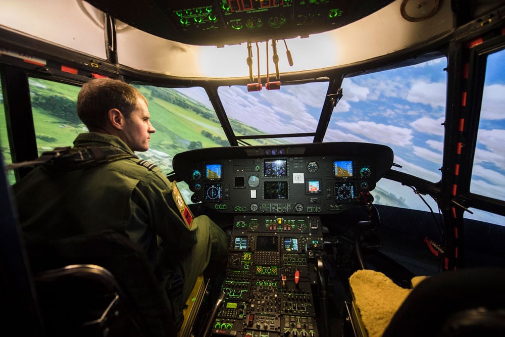 A pilot inside a helicopter simulator