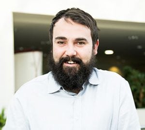 Project Manager with beard smiling