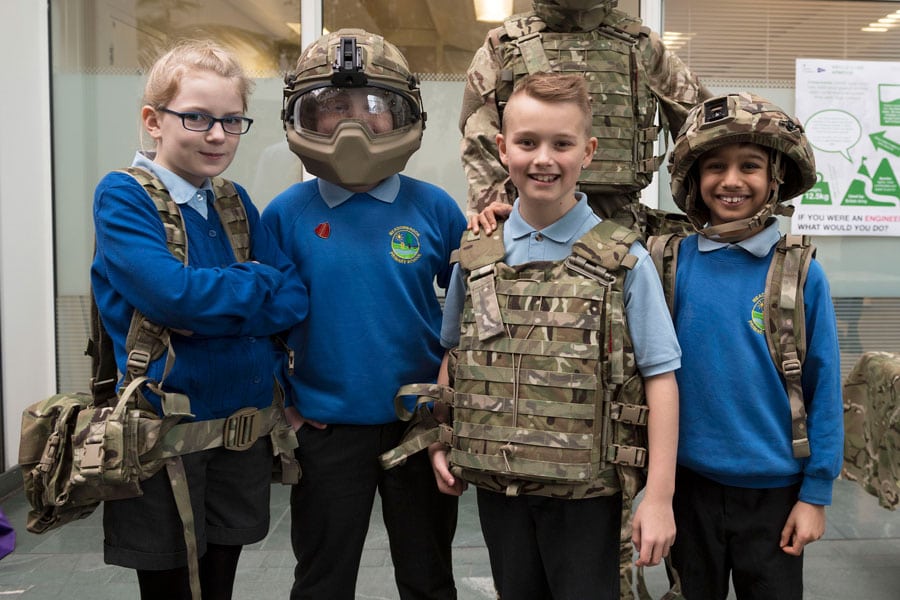 primary school children try on bulletproof vests