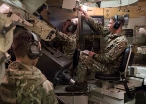 solider in a tank simulator wearing headset