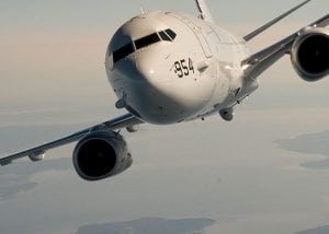 A white plane flies towards the camera