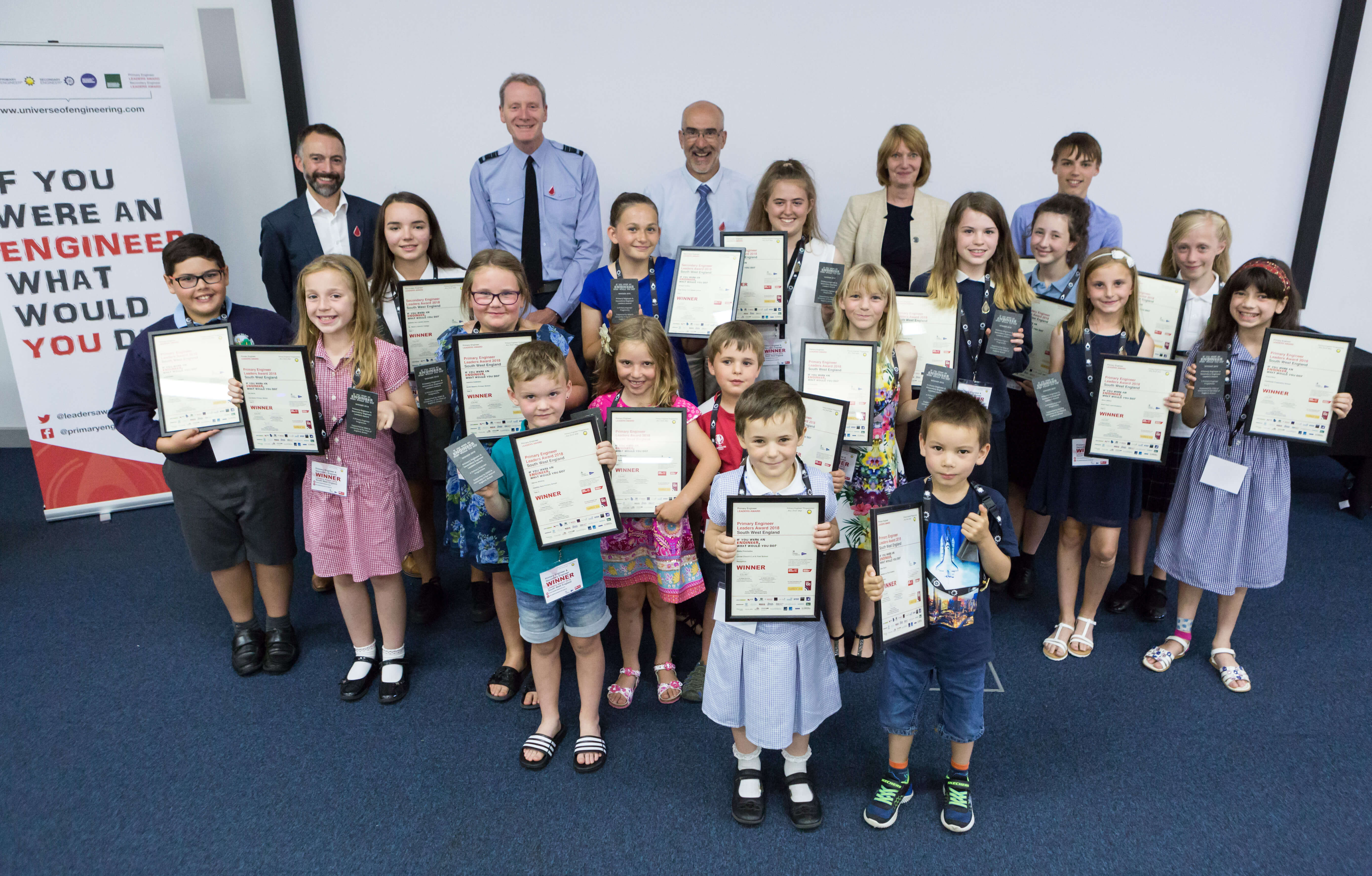 A group of children show off their awards certificates