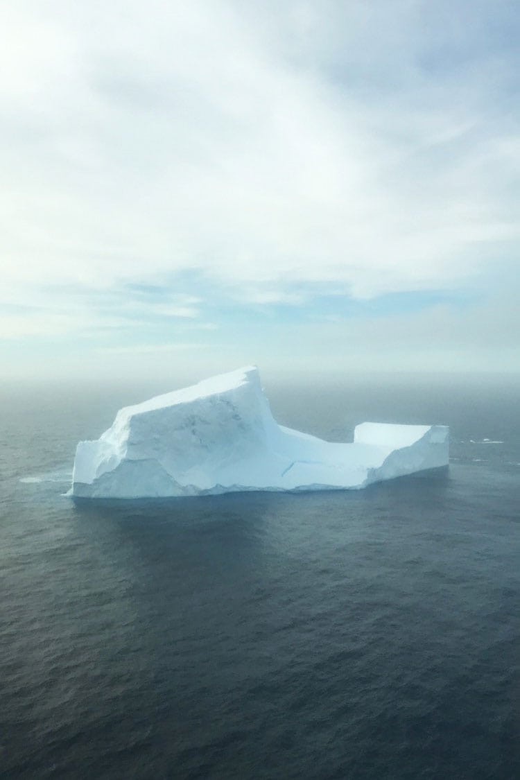 A large white iceberg drifts on the ocean