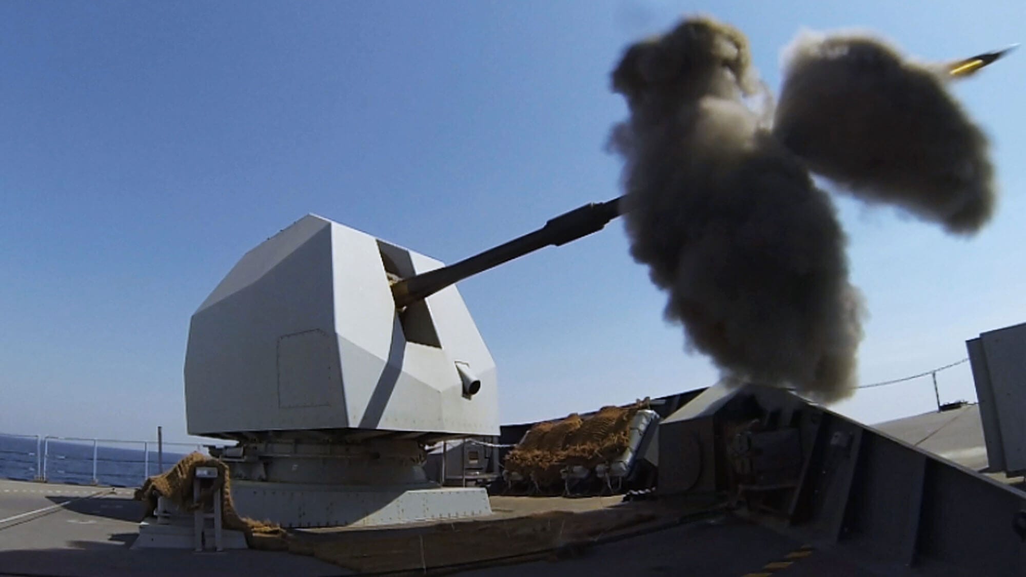 Mark 8 naval gun firing a 4.5” shell out to sea from Royal Navy ship