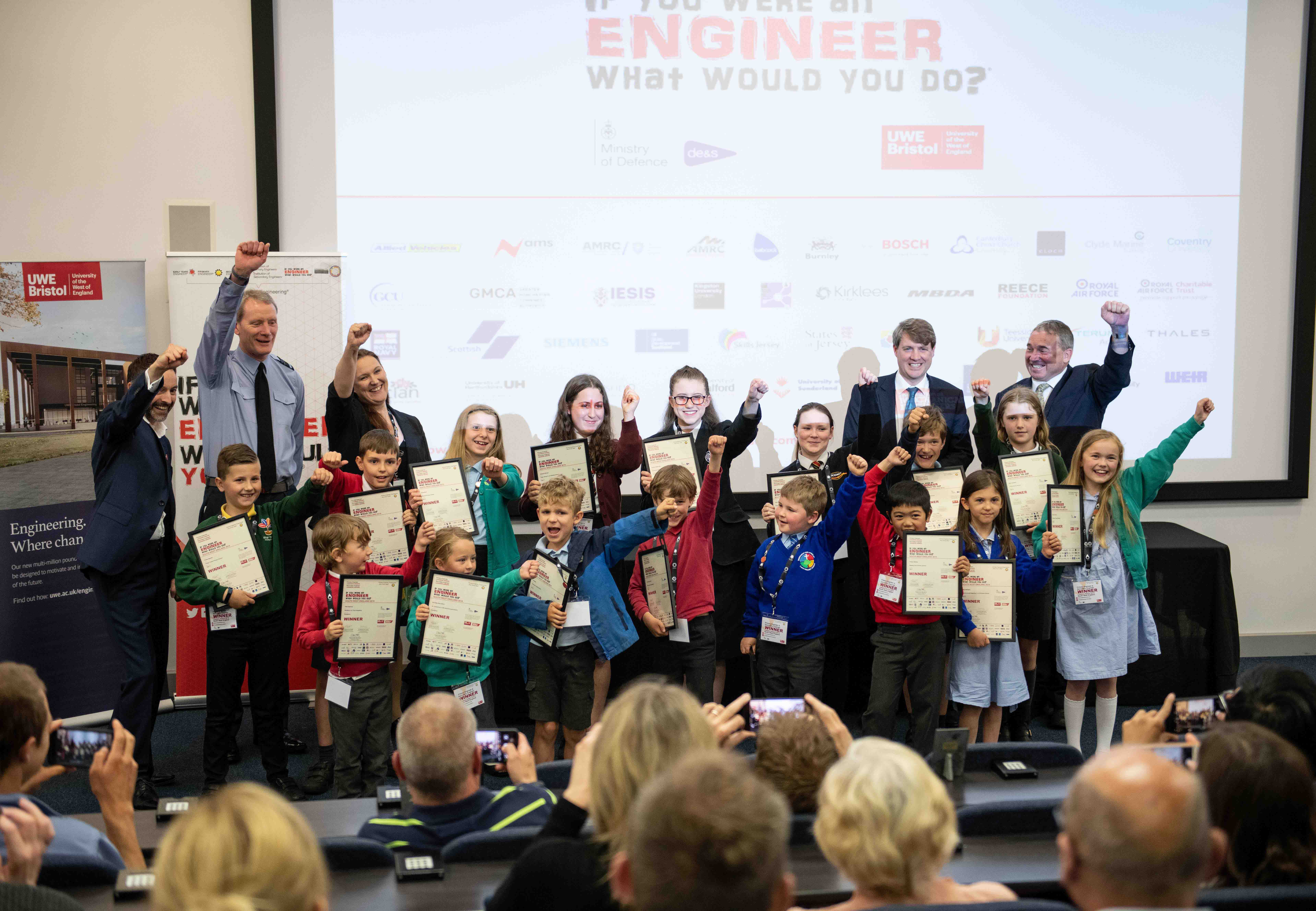 School children celebrating as a group, having received their awards for winning an engineering design competition
