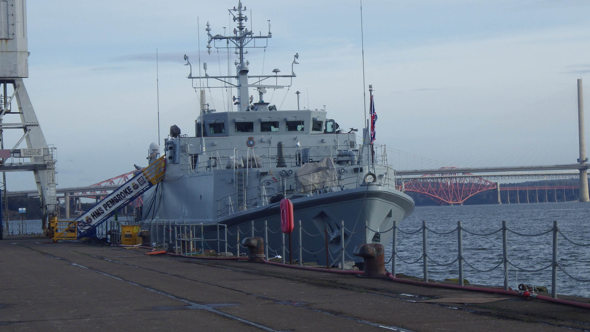 A naval ship at dockside