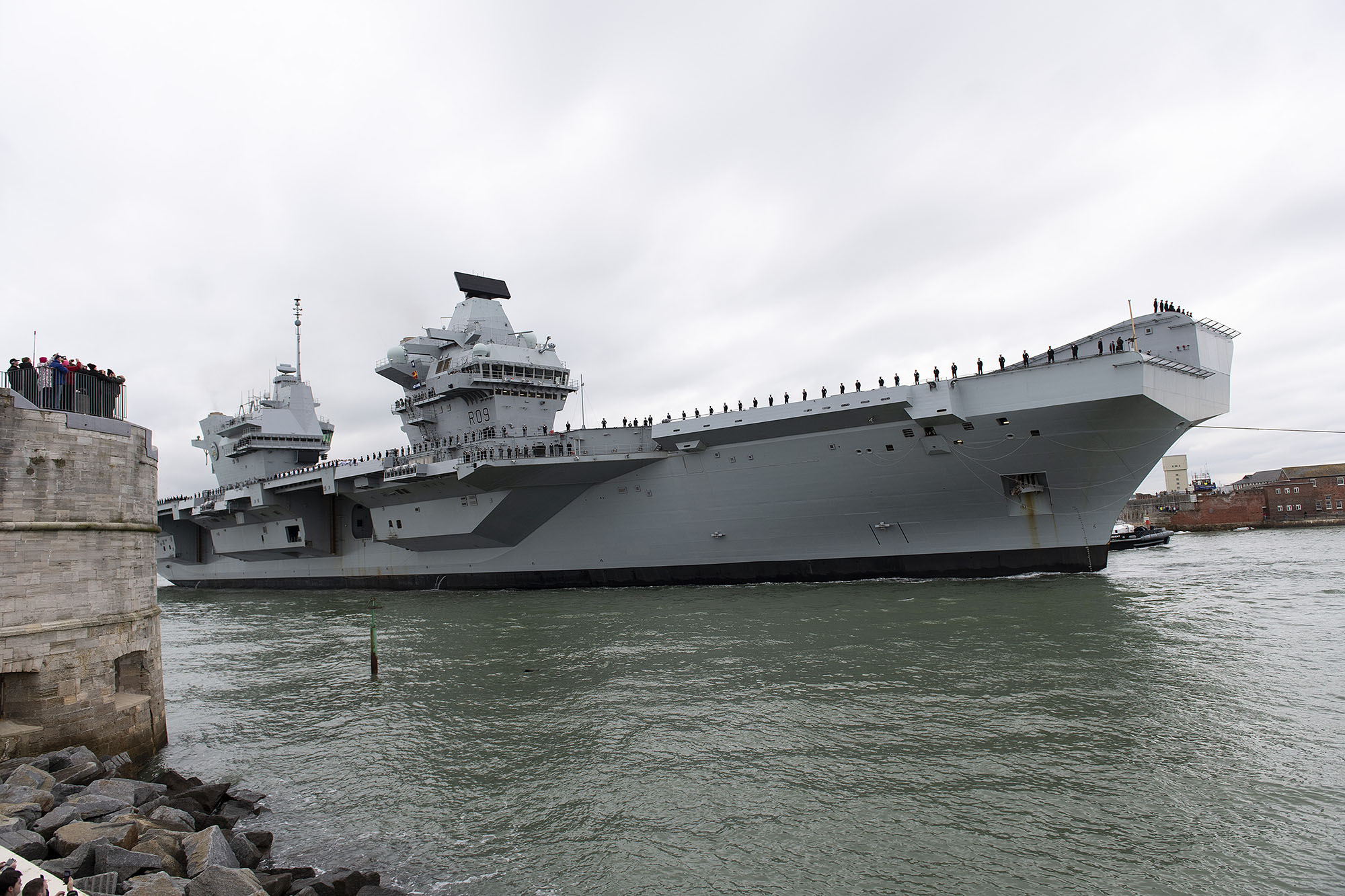 Large Royal Navy ship sailing into Portsmouth harbour