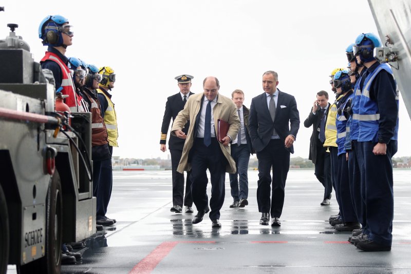 Defence Secretary walks along the deck of HMS Queen Elizabeth as he arrives for the Atlantic Future Forum