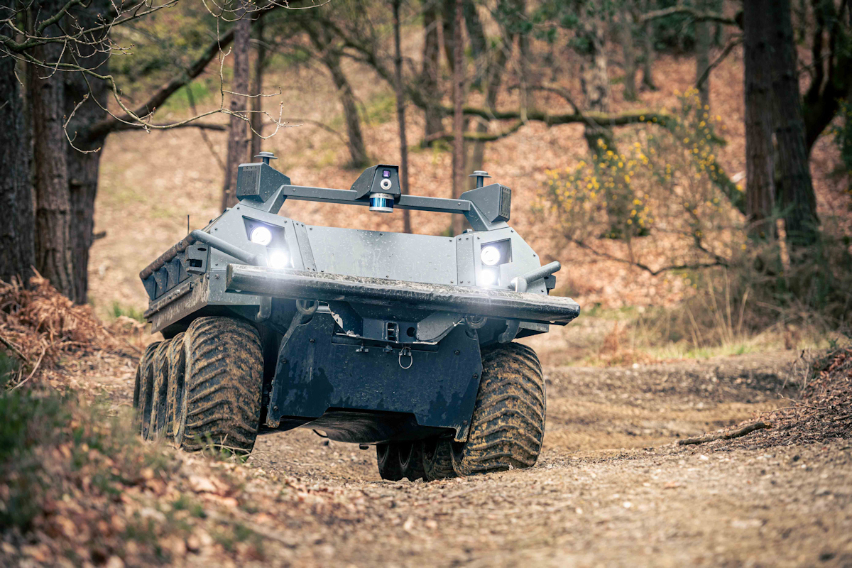 Six-wheel autonomous vehicle driving over muddy terrain