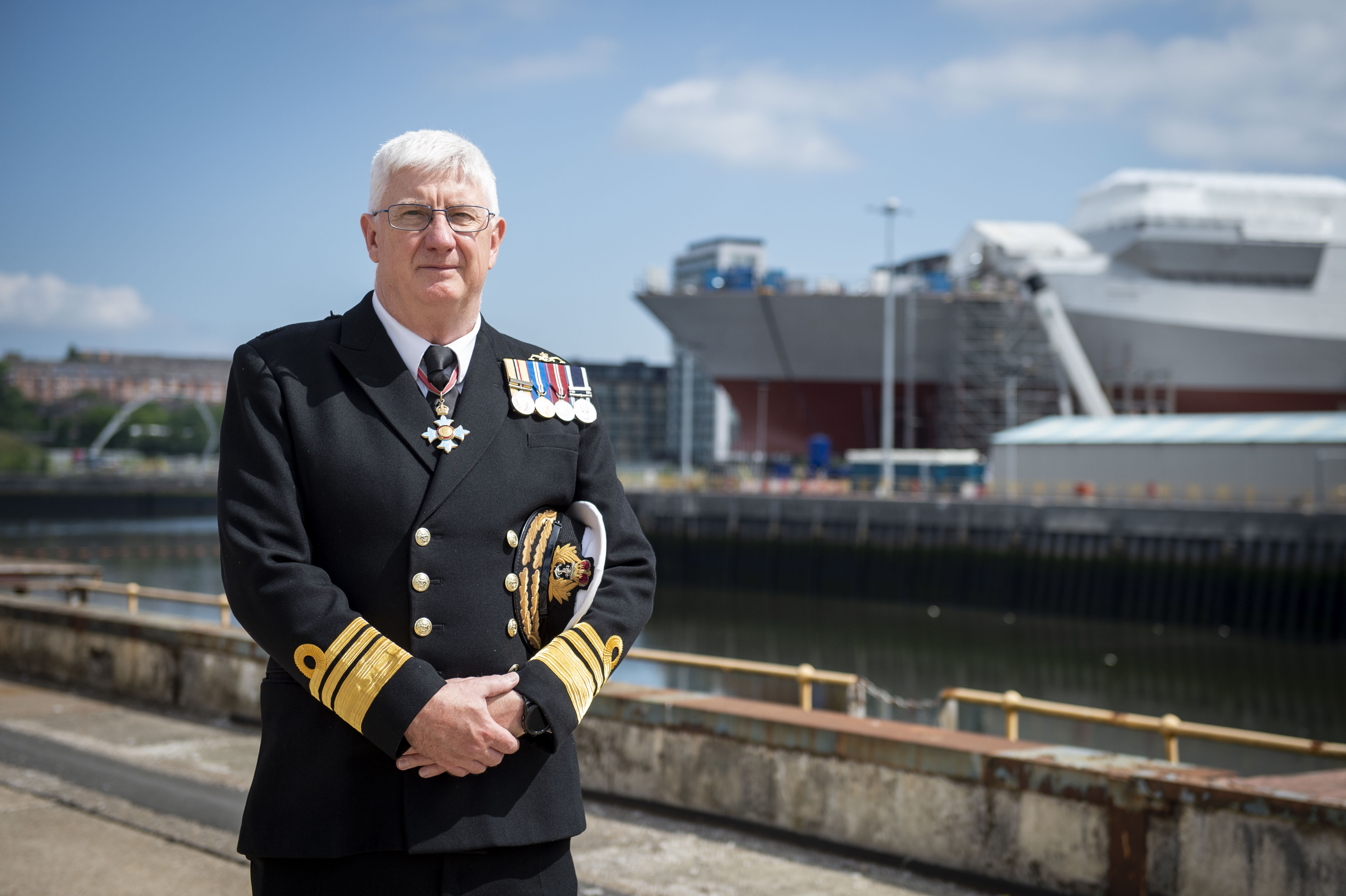 DE&S DG Ships Chris Gardner in front of HMS Glasgow at Govan dockyard