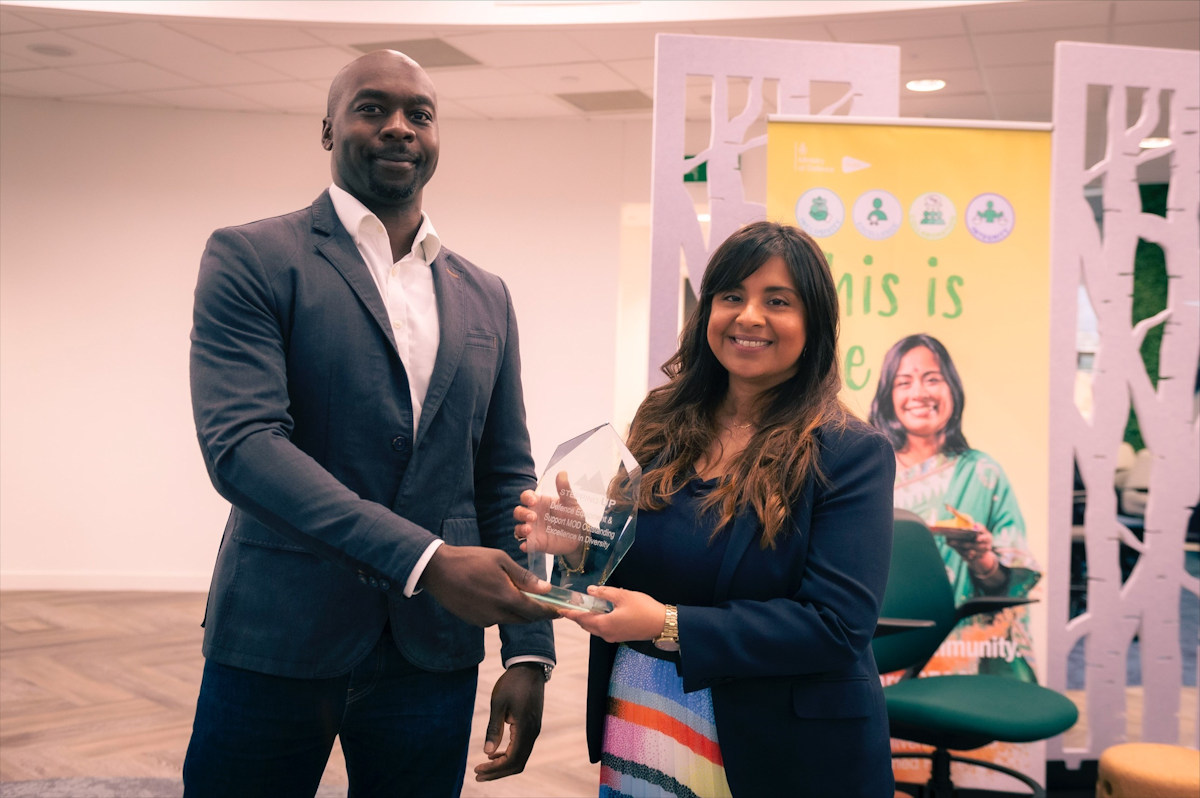 Kevin Millwood, Chair of the Stepping Up Stakeholder Board presenting Krishna Dhanak,Director Strategy and Corporate Operations and DE&S Race Champion with the Stepping Up Diversity Champion Excellence Award