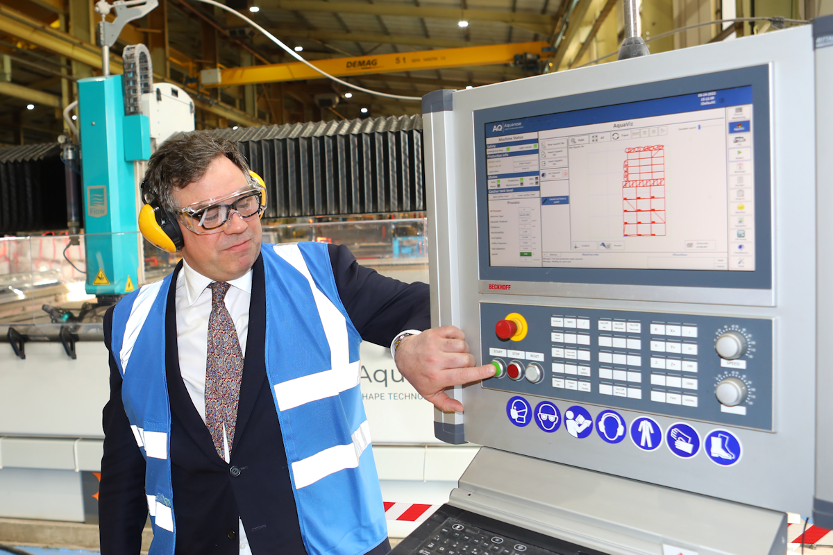 Minister for Defence Procurement , Jeremy Quin, operates the water-jet cutter which was used to cut the first piece of steel for the Challenger 3 turret structure at Pearson Engineering, Armstrong Works, Newcastle upon Tyne