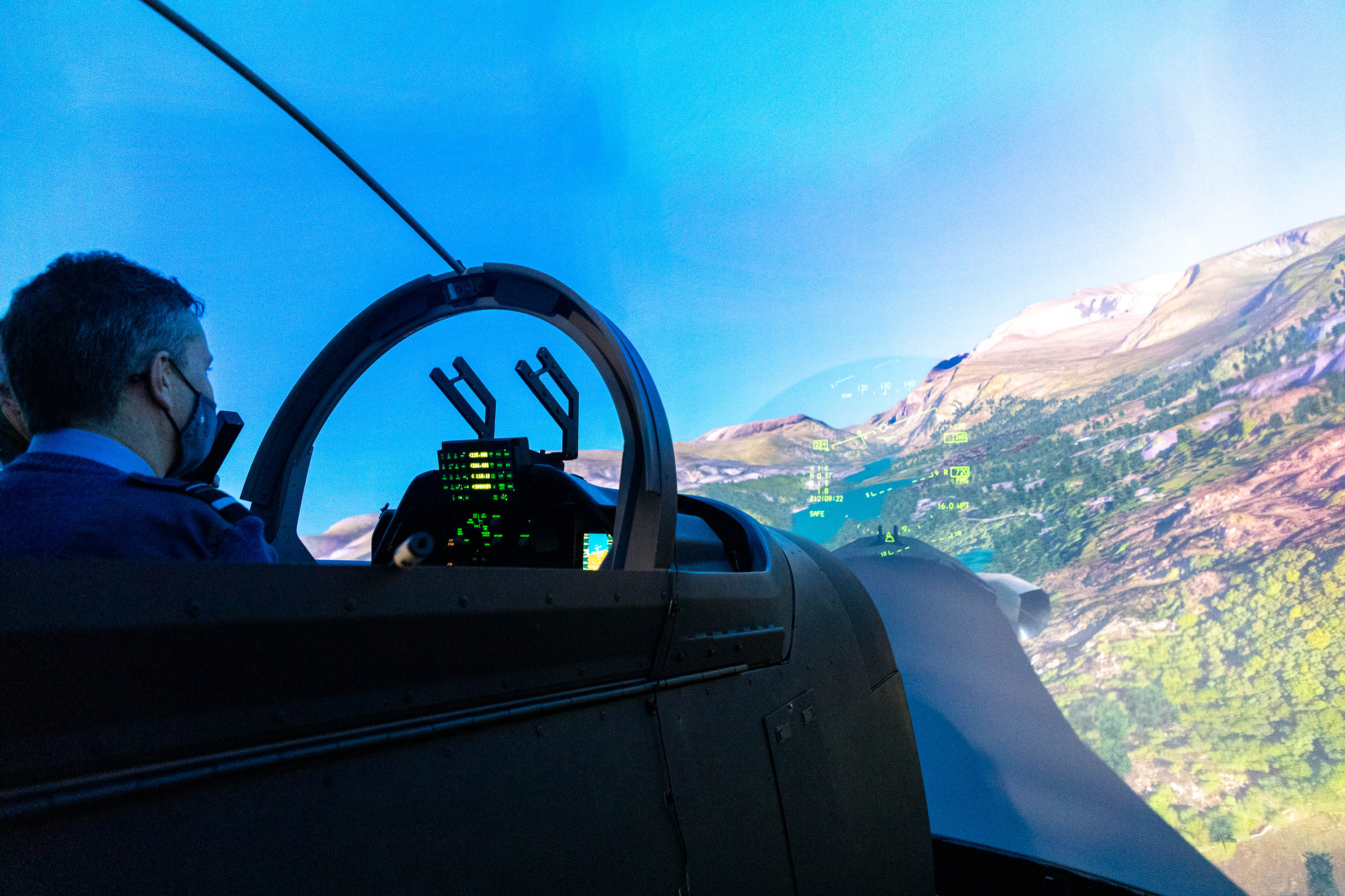 Air Vice Marshal Ellard tries out the virtual reality flight simulator, which is used in the fast-jet training programme.