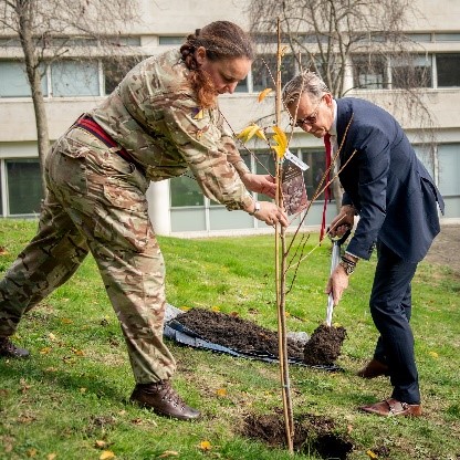 DE&S CEO planting tree with assistance of female solider