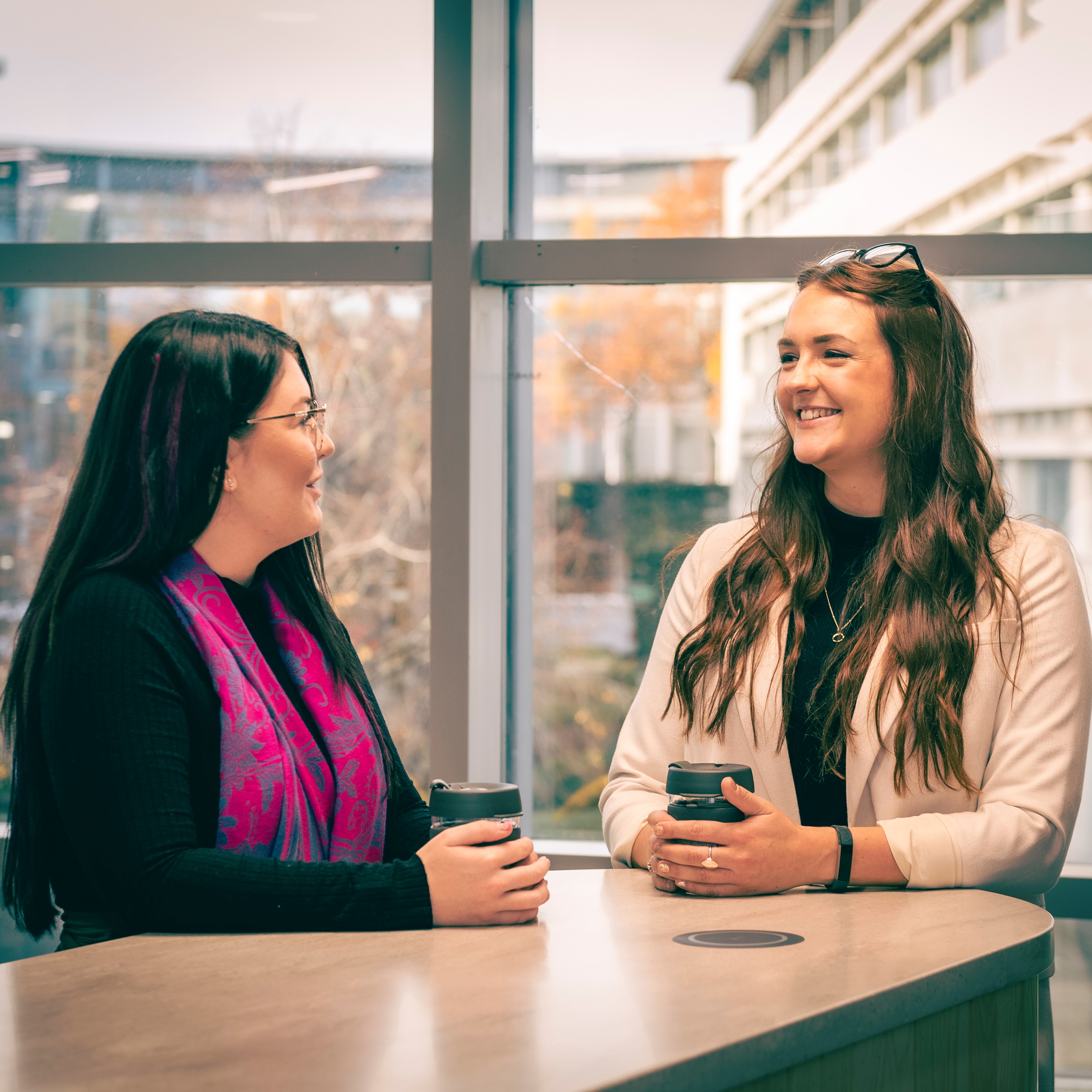 Two women talking around a table