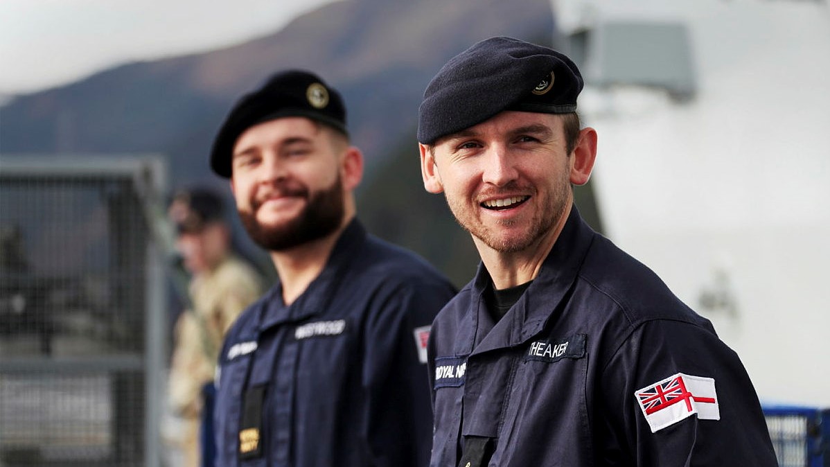 Two Royal Naval personnel onboard a vessel
