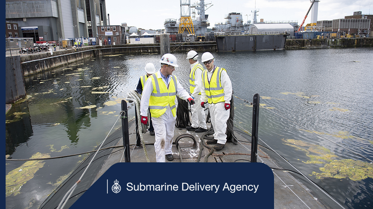 A group of people inspecting a submarine