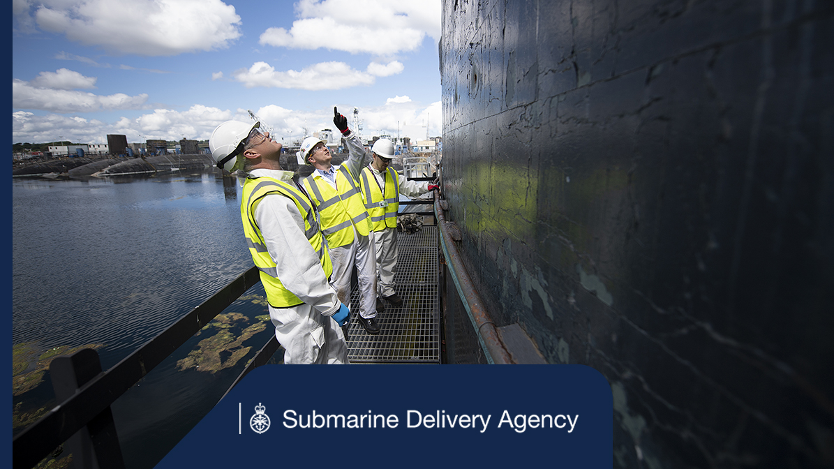 A group of people pointing at a submarine