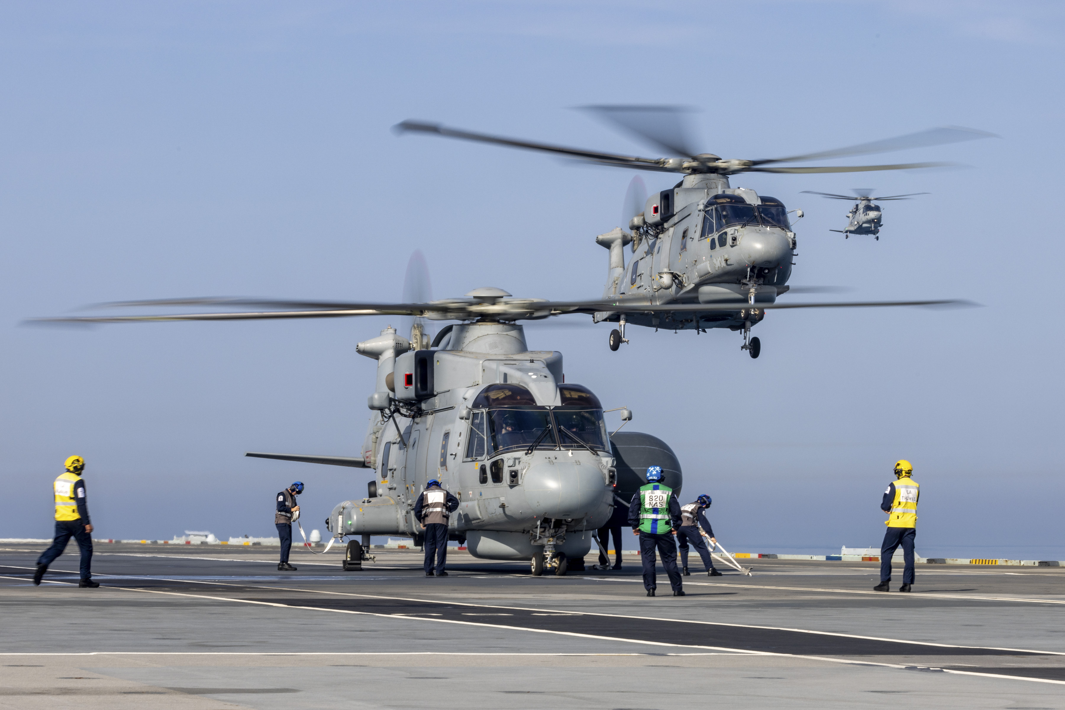 A Merlin helicopter on the deck of HMS Queen Elizabeth during the Carrier Strike Group deployment 2023