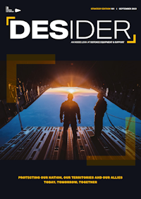 September 2023 Desider front cover showing two people standing on the ramp of the open rear door of a transport plane looking at sunrise on the horizan