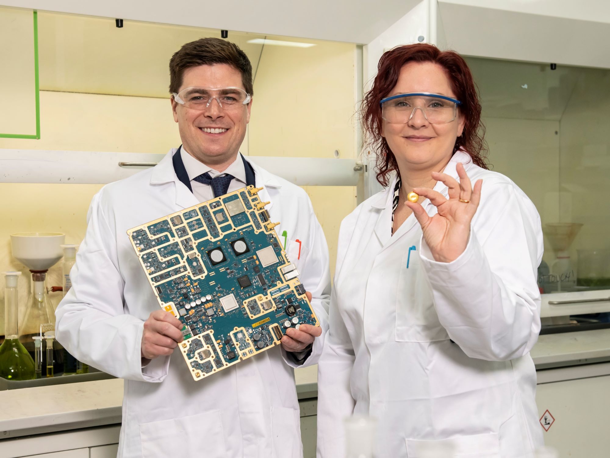 Mark Loveridge, of The Royal Mint, and Jennifer Willis, DESA Head Recycling, holding electrical equipment which will be treated to extract precious minerals.