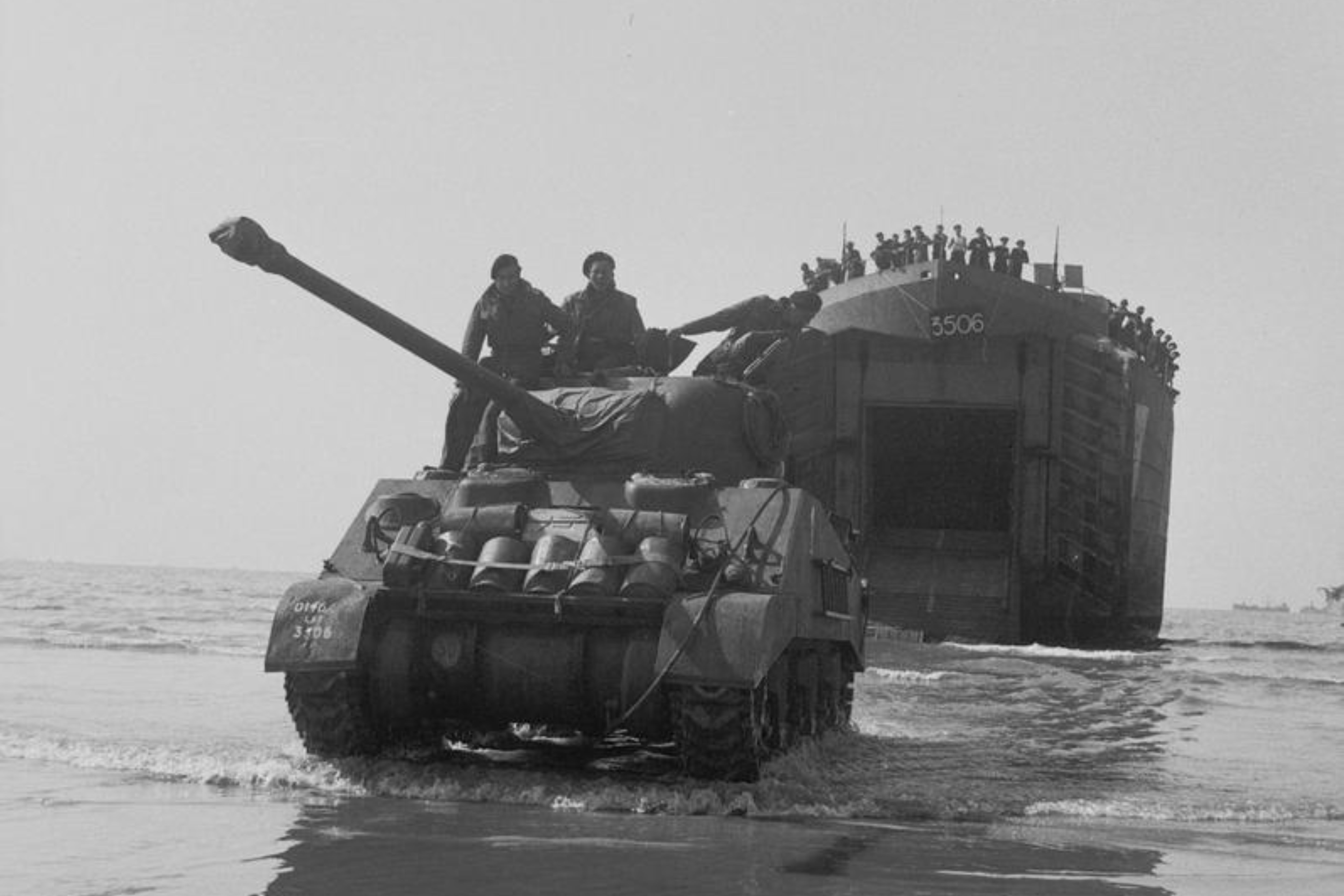 A Sherman Firefly of 22nd Armoured Brigade, 7th Armoured Division comes ashore from an LST (Landing Ship Tank), Gold area, 7 June 1944.