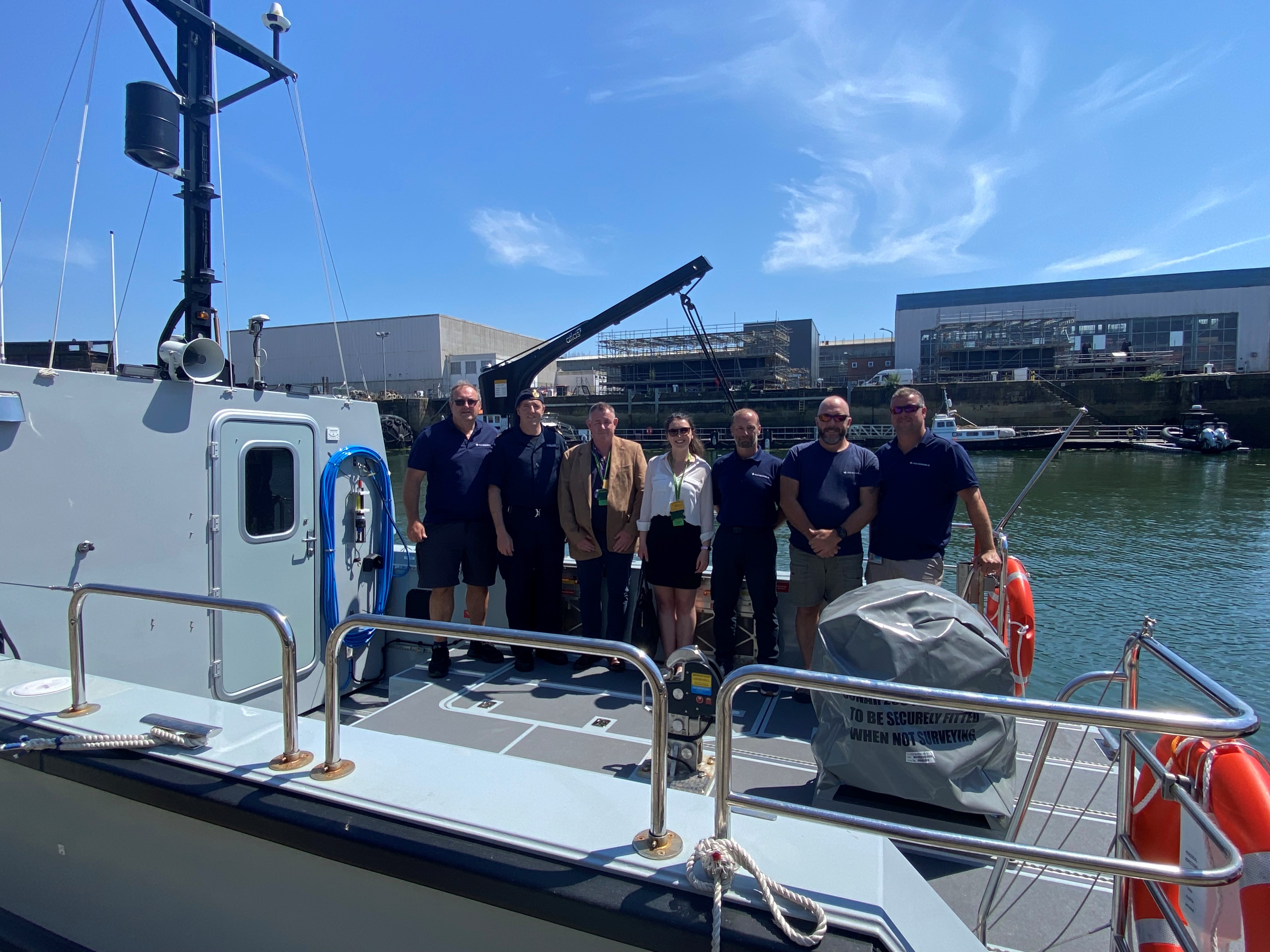 Members of DE&S on board one of the last Vahana workboats delivered to the Royal Navy