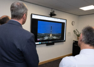 Personnel from UK Space Command, DE&S and SSTL watch live as the Tyche satellite is launched from the SpaceX Falcon 9 re-usable rocket