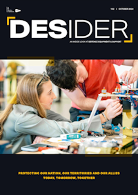 Deisder magazine front cover showing young man and young woman working in electrical components attached to a wooden with three metal legs