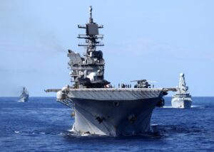 HMS Queen Elizabeth leads the Royal Navy Carrier Strike Group and allied vessels during a deployment