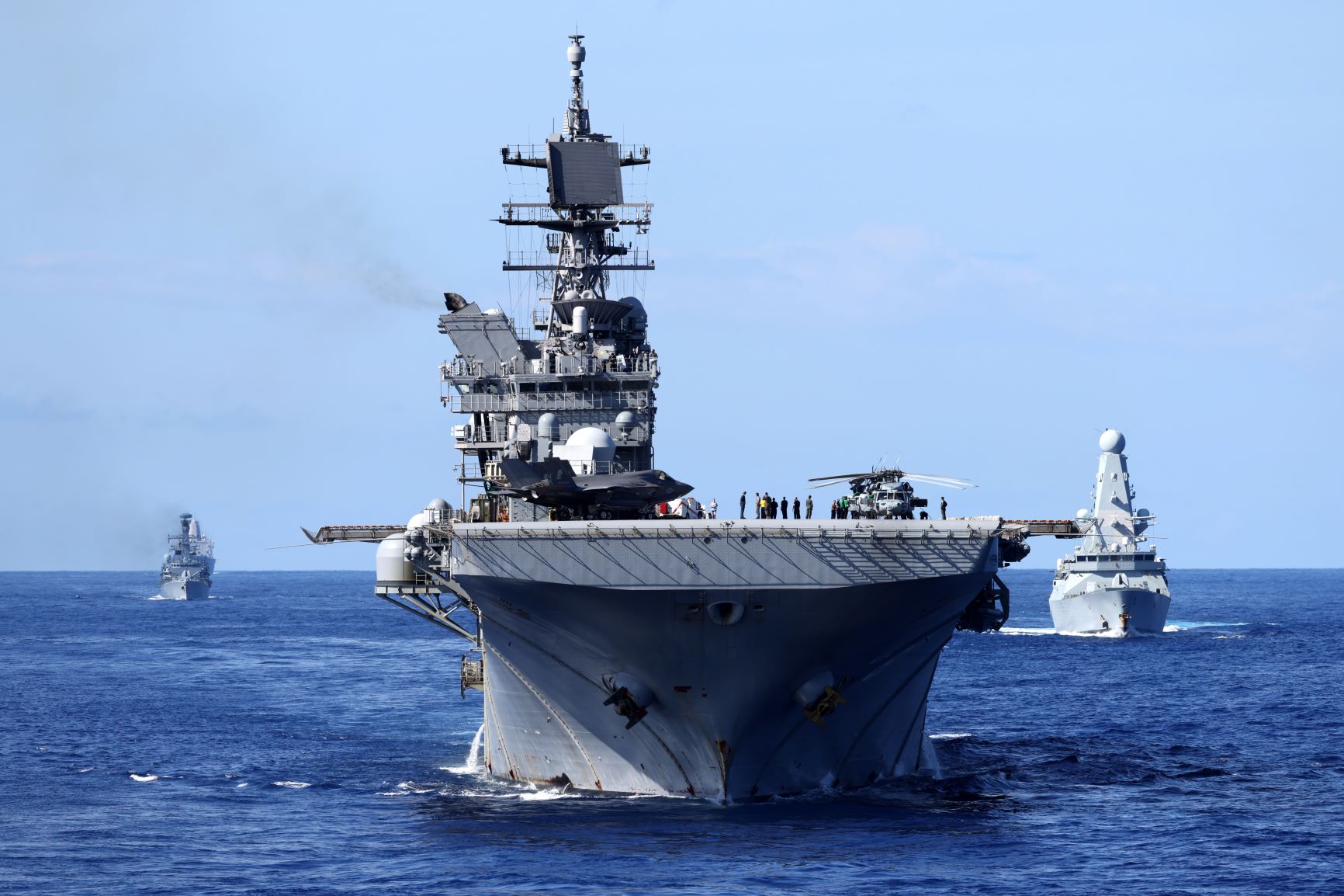 HMS Queen Elizabeth leads the Royal Navy Carrier Strike Group and allied vessels during a deployment