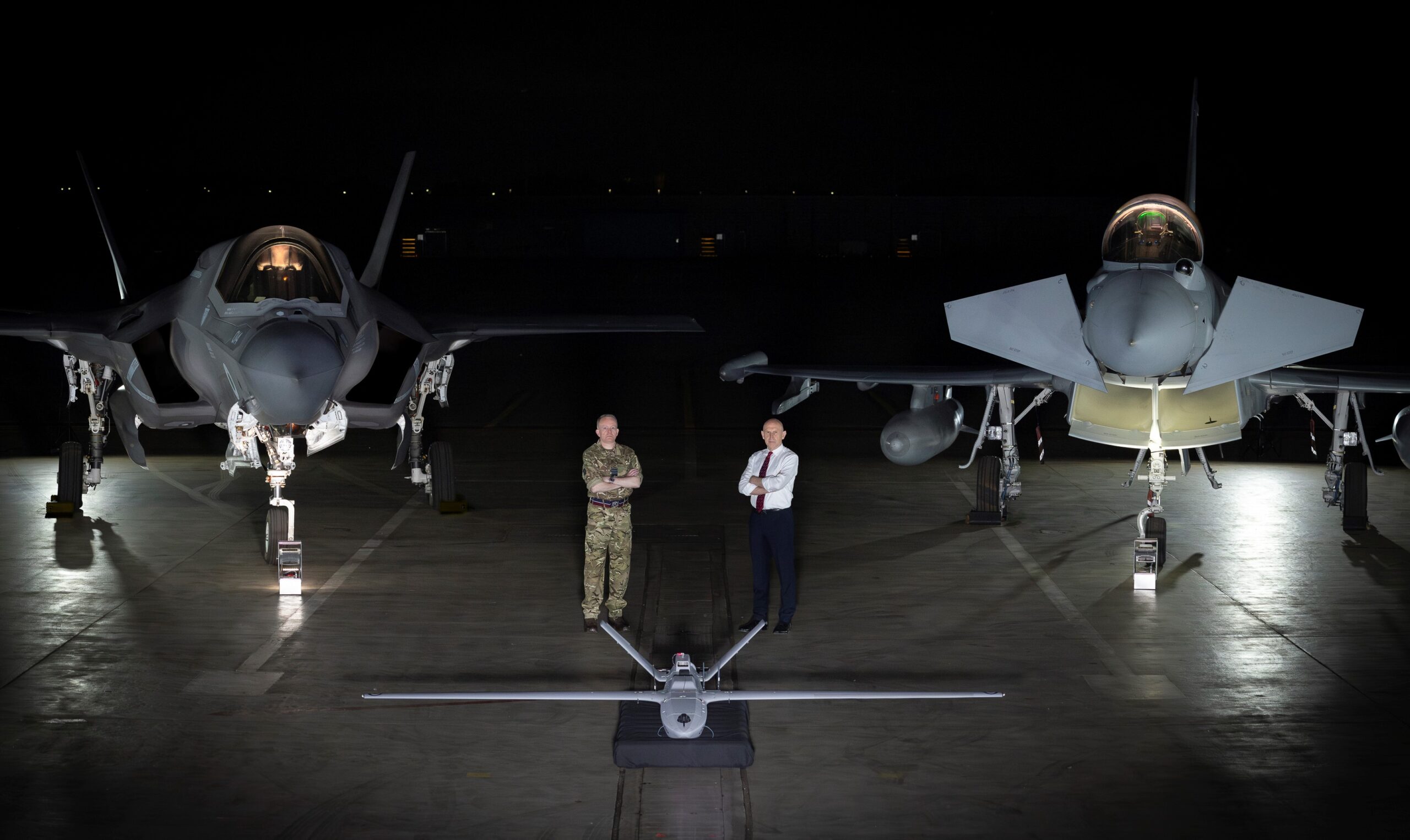 Chief of the Air Staff, Air Marshal Sir Richard Knighton, and Defence Secretary John Healey with a StormShroud drone, F-35B and Typhoon at RAF Waddington.