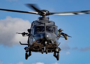 A front-on view of a Leonardo AW149 helicopter flying