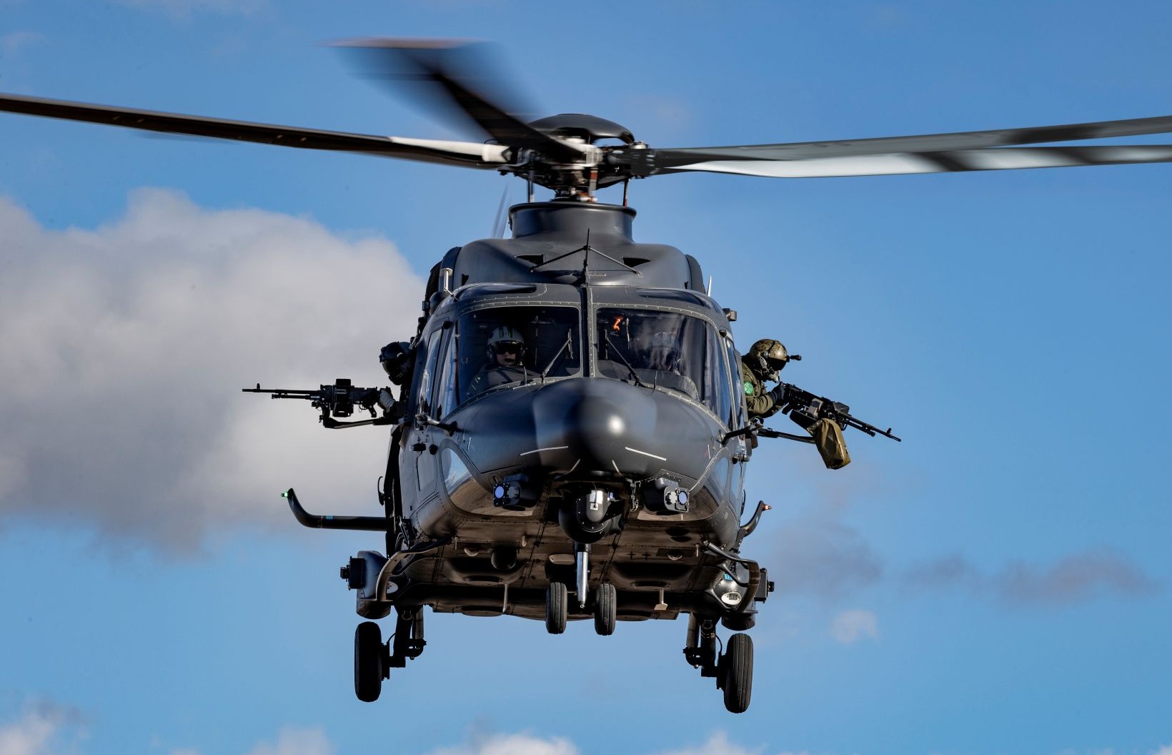 A front-on view of a Leonardo AW149 helicopter flying